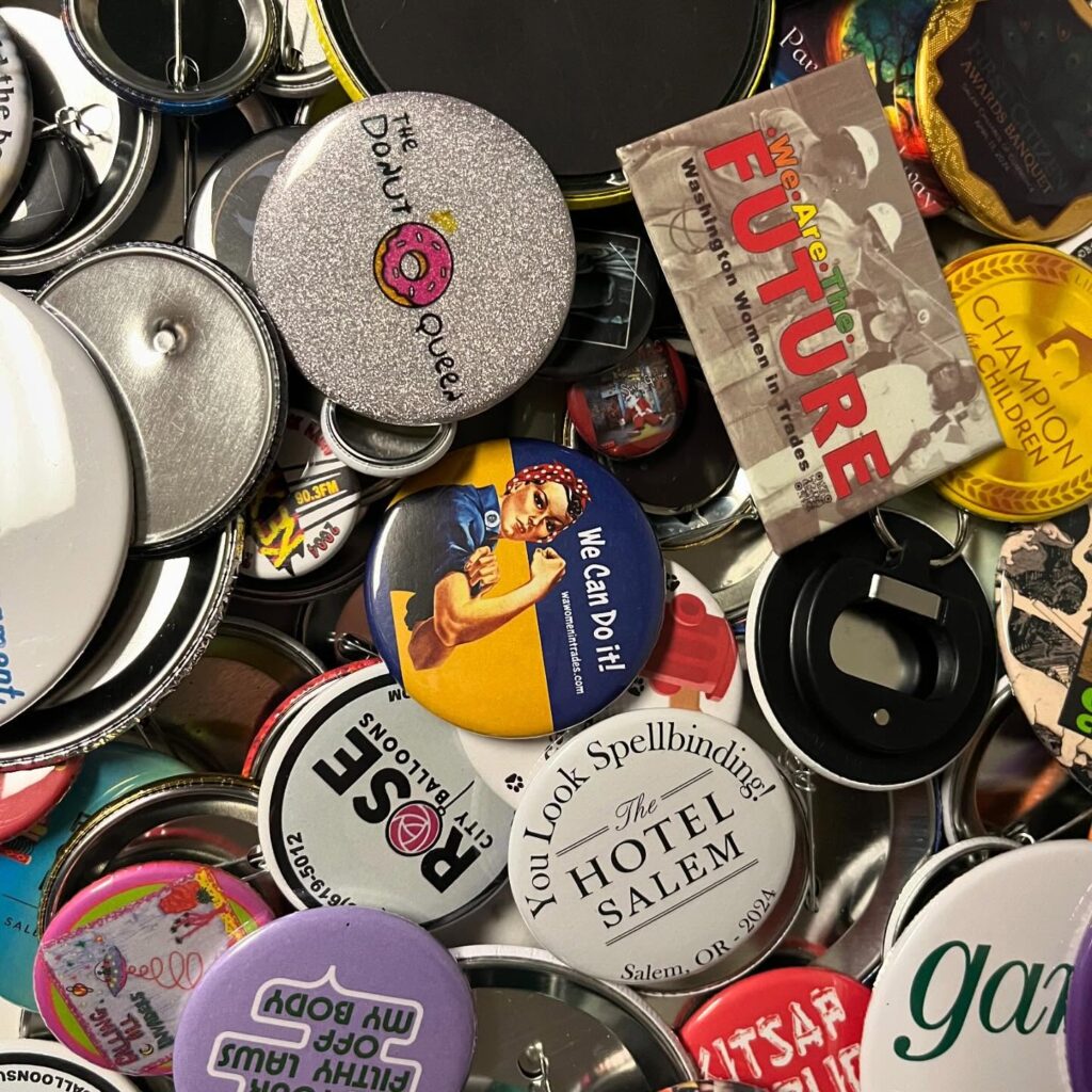 Close-up of custom pinback buttons made by Becka Makes Buttons featuring unique designs and vibrant colors